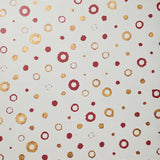 Detail of wallpaper in an irregular polka dot print in shades of gold and red on a white field.