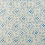 Detail of fabric in a painterly damask print in blue on a cream field.