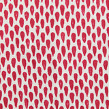 Detail of fabric in a painterly teardrop print in red on a cream field.