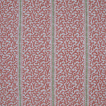 Printed fabric detail in a geometric rhythmic stripe in a warm pink with a light green accent. 