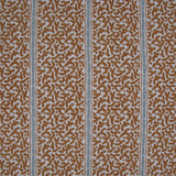 Printed fabric detail in a geometric rhythmic stripe in warm brown with a light blue accent