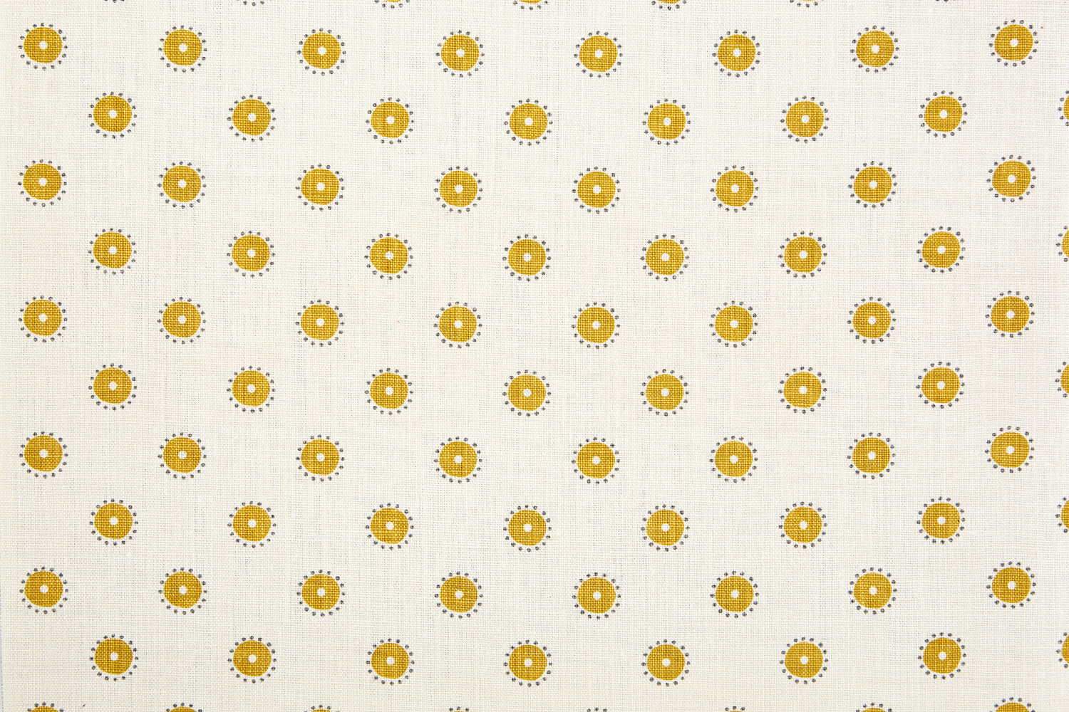 Detail of fabric in a playful dot print in mustard and gray on a cream field.