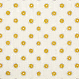 Detail of fabric in a playful dot print in mustard and gray on a cream field.