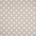 Detail of fabric in a playful dot print in gray and white on a gray field.