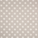 Detail of fabric in a playful dot print in gray and white on a gray field.