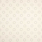 Detail of fabric in a playful dot print in charcoal on a cream field.