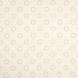 Detail of fabric in a playful dot print in charcoal on a cream field.