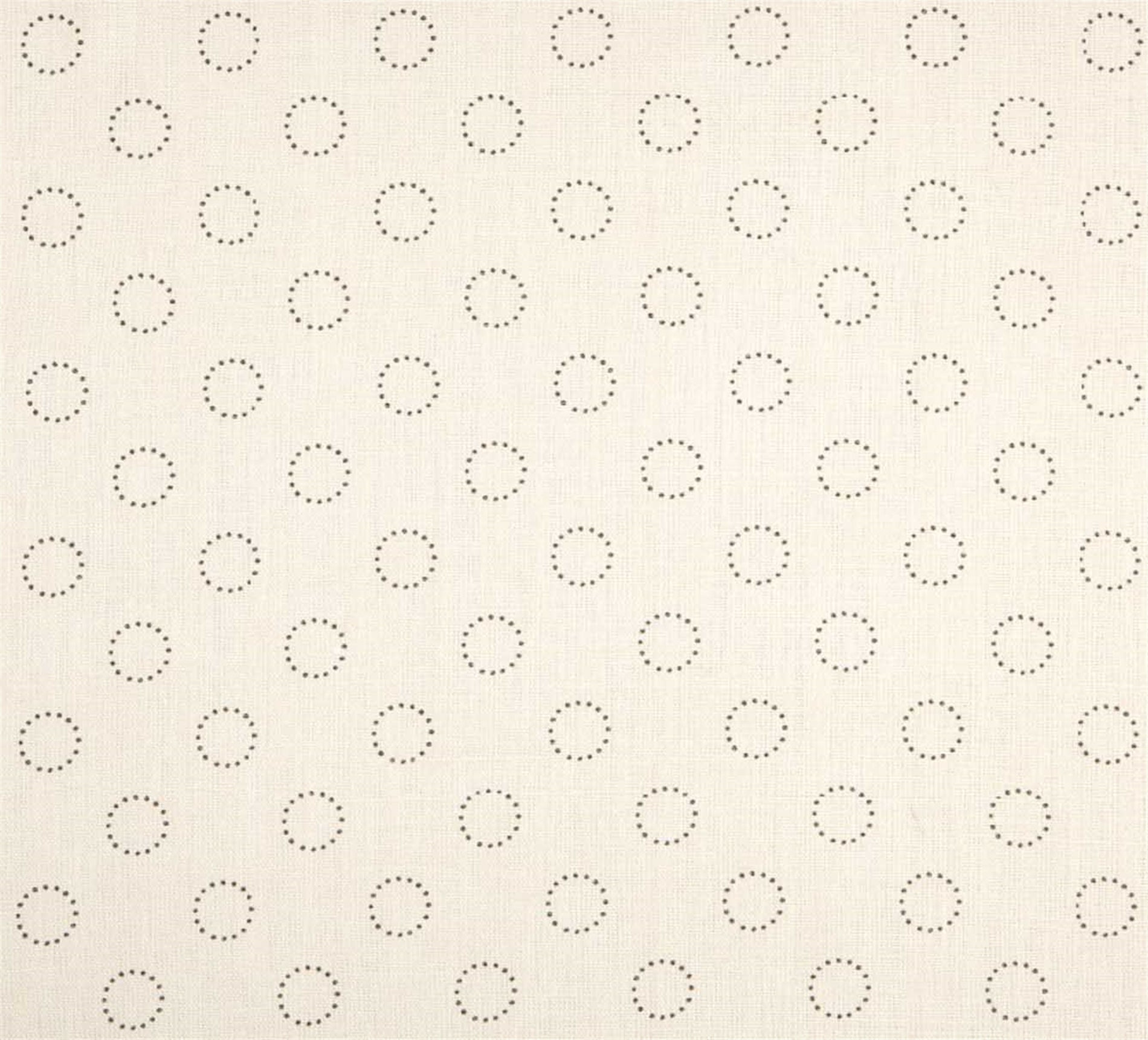 Detail of fabric in a playful dot print in charcoal on a cream field.