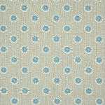 Detail of fabric in a playful dot print in blue and white on a gray field.