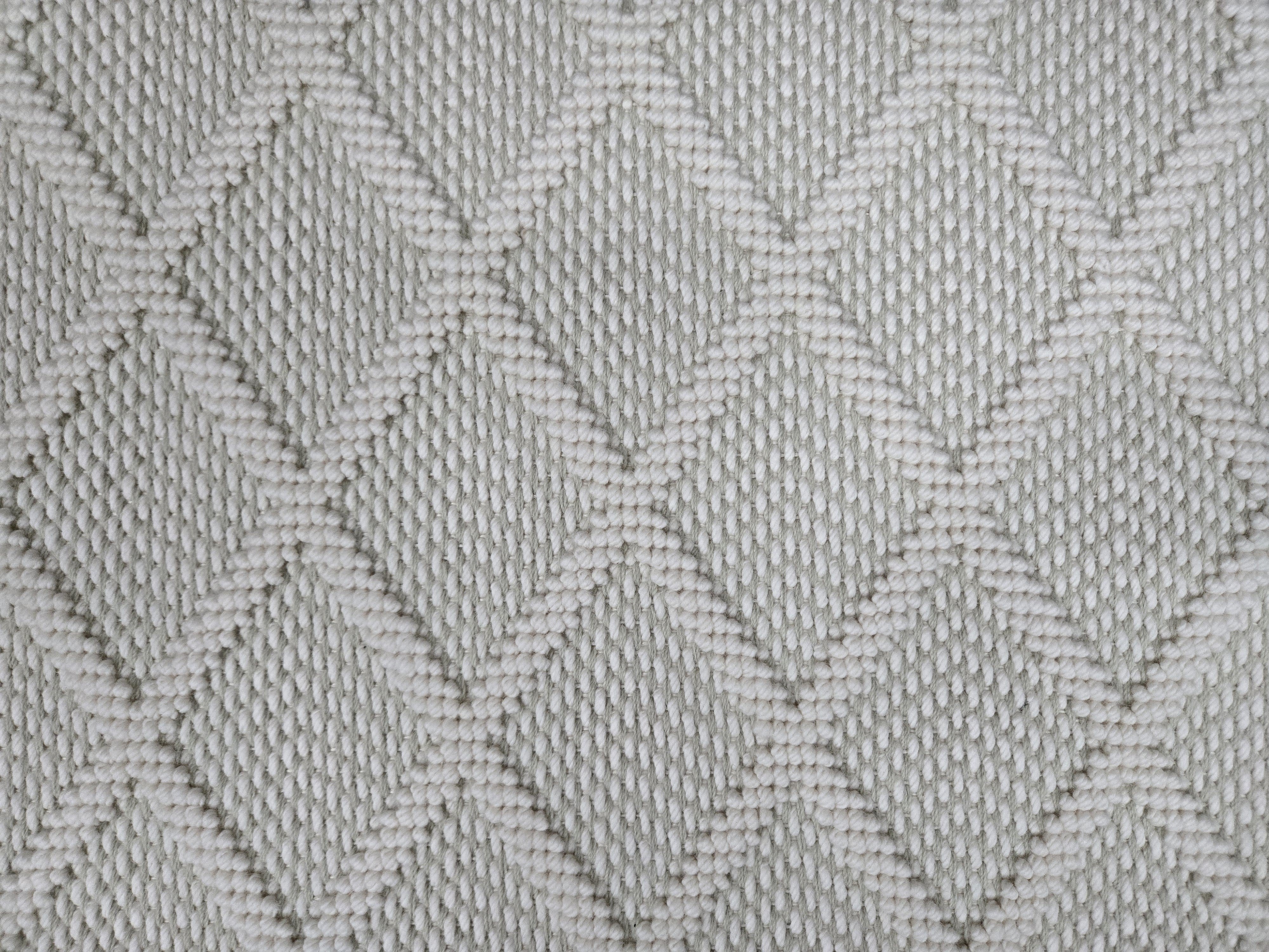 Broadloom carpet in a dimension diamond lattice in cream and grey-green