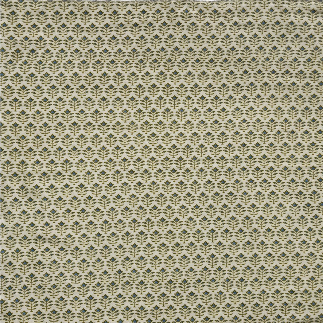 Detail of fabric in a small-scale floral grid print in green on a cream field.