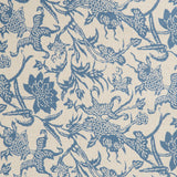 Detail of a linen fabric in a carp and leaf pattern in blue on a beige field.