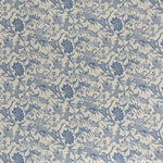 printed linen fabric in a carp and leaf pattern in blue on a beige field.