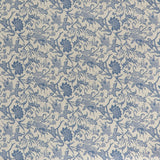 printed linen fabric in a carp and leaf pattern in blue on a beige field.