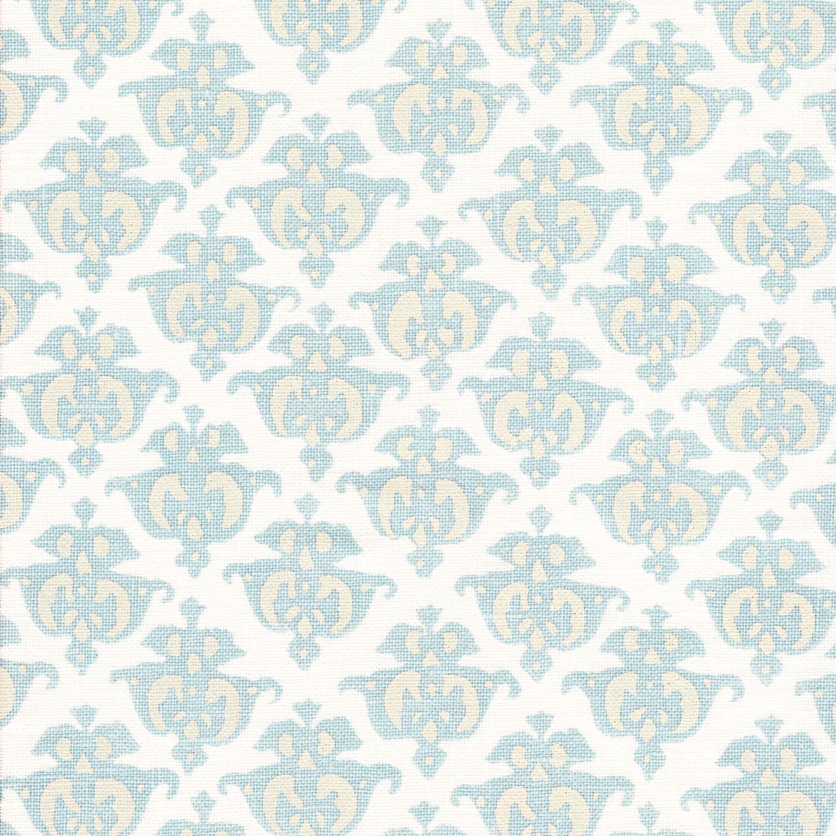 Detail of fabric in a repeating damask print in blue and yellow on a white field.