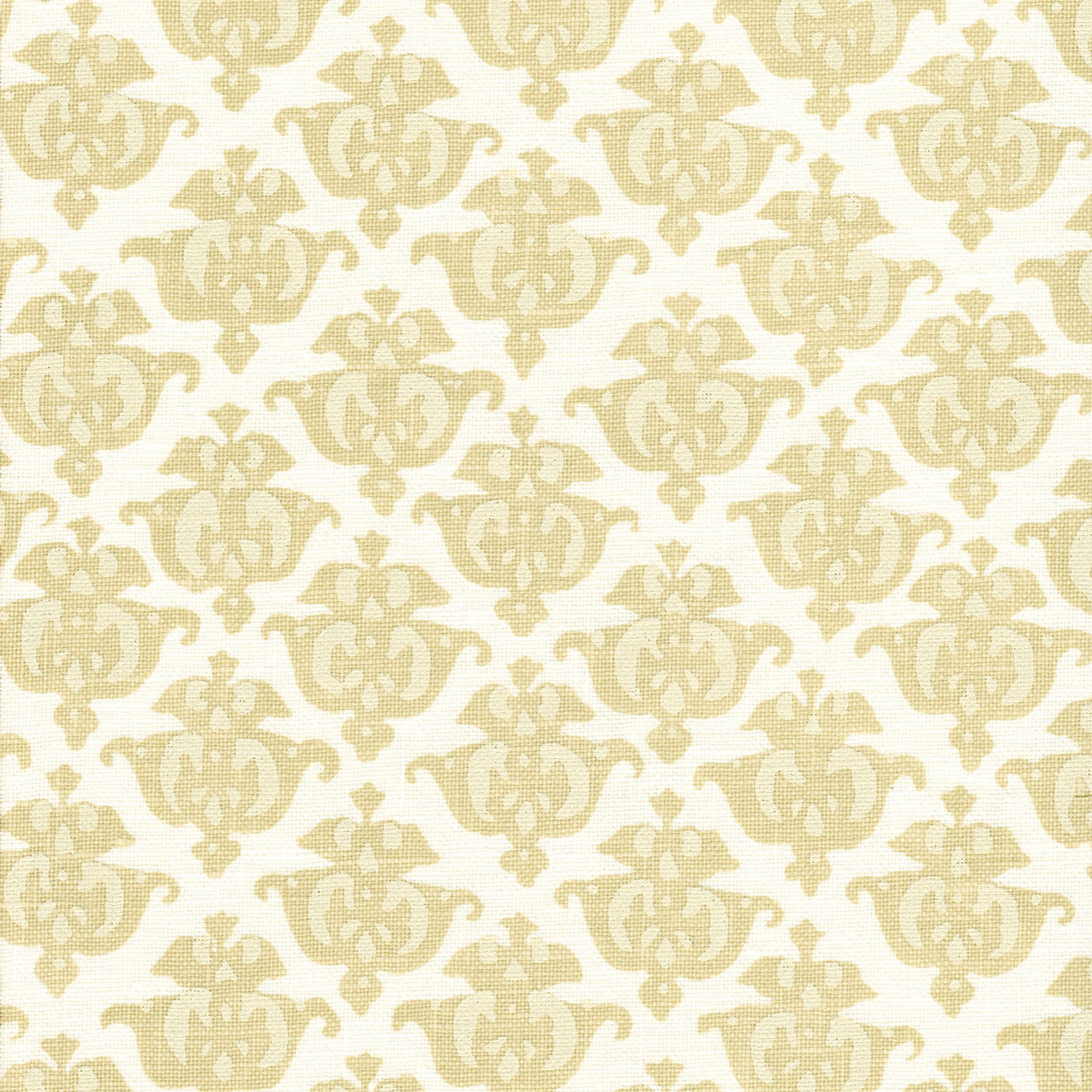 Detail of fabric in a repeating damask print in tan and cream on a white field.