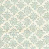 Detail of fabric in a repeating damask print in blue and tan on a cream field.