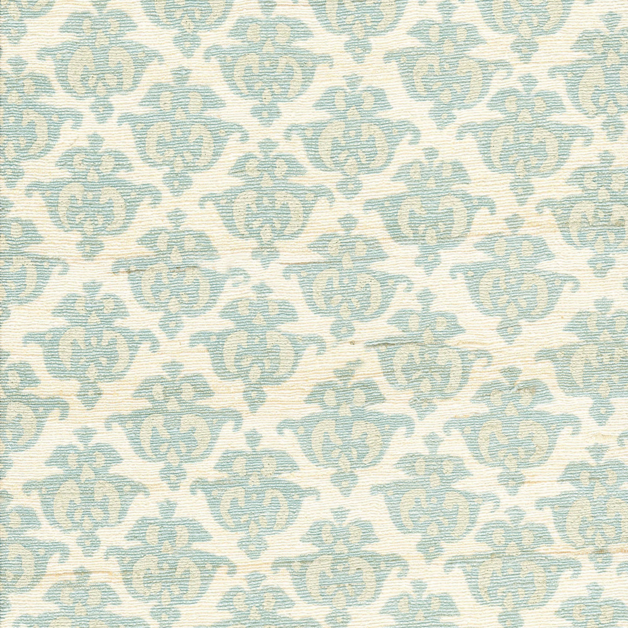 Detail of fabric in a repeating damask print in blue and tan on a cream field.