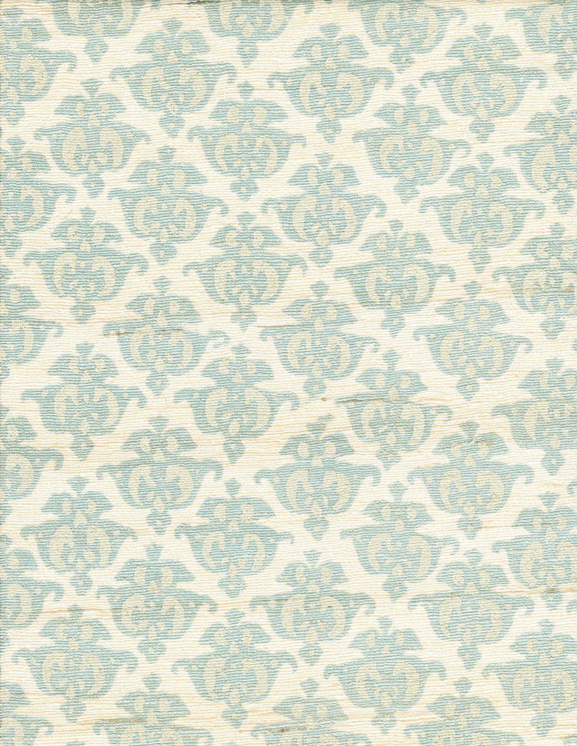 Detail of fabric in a repeating damask print in blue and tan on a cream field.