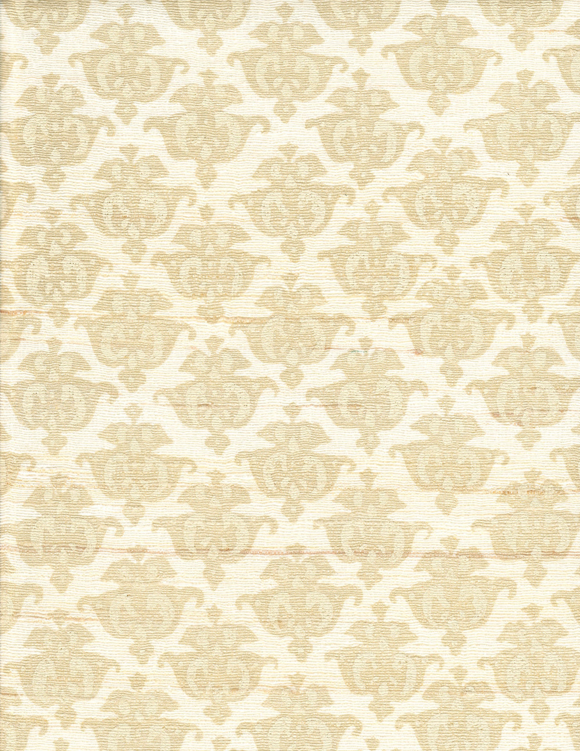 Detail of fabric in a repeating damask print in tan and cream on a white field.