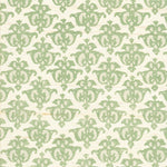 Detail of fabric in a repeating damask print in green and tan on a cream field.