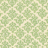 Detail of wallpaper in a repeating damask print in green on a cream field.