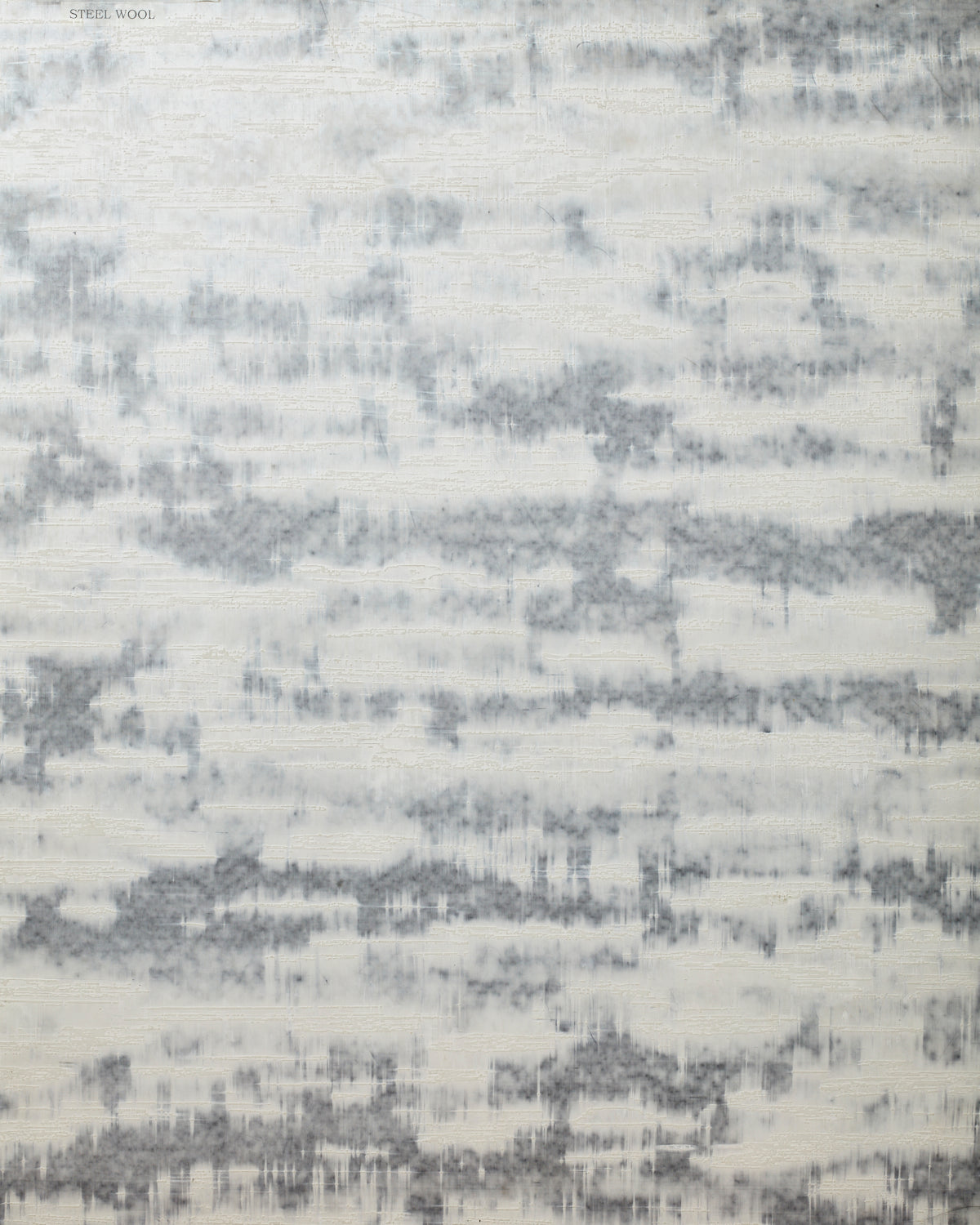 Detail of wallpaper in an abstract textural pattern in gray on a cream field.