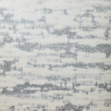 Detail of wallpaper in an abstract textural pattern in gray on a cream field.