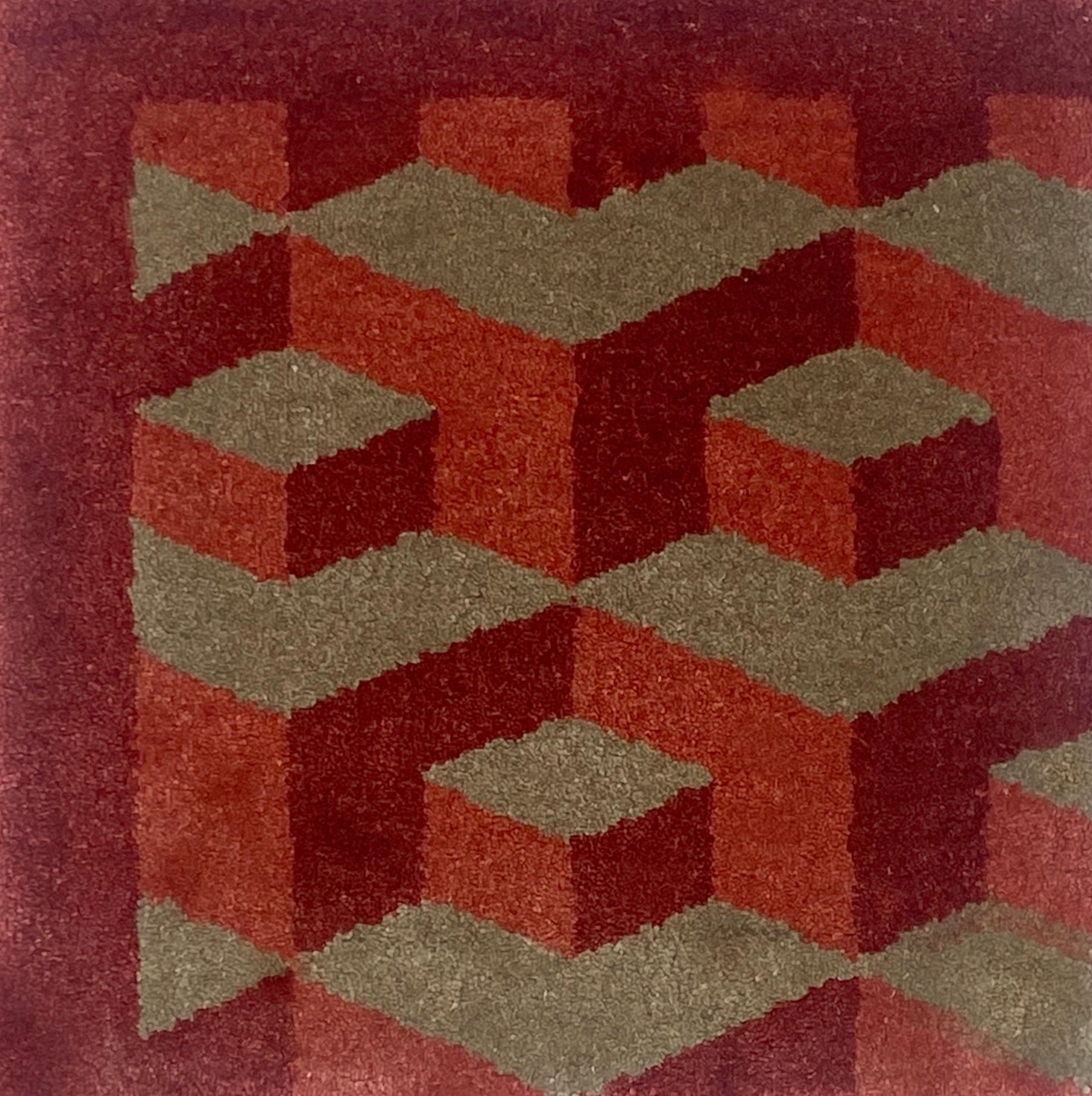 Geometric patterned rug with red and brown colors