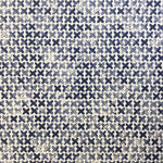 Detail of fabric in a repeating "X" print in indigo on a cream field.