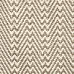 Flatweave rug with a zigzag pattern in beige and brown on a neutral background