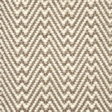 Flatweave rug with a zigzag pattern in beige and brown on a neutral background