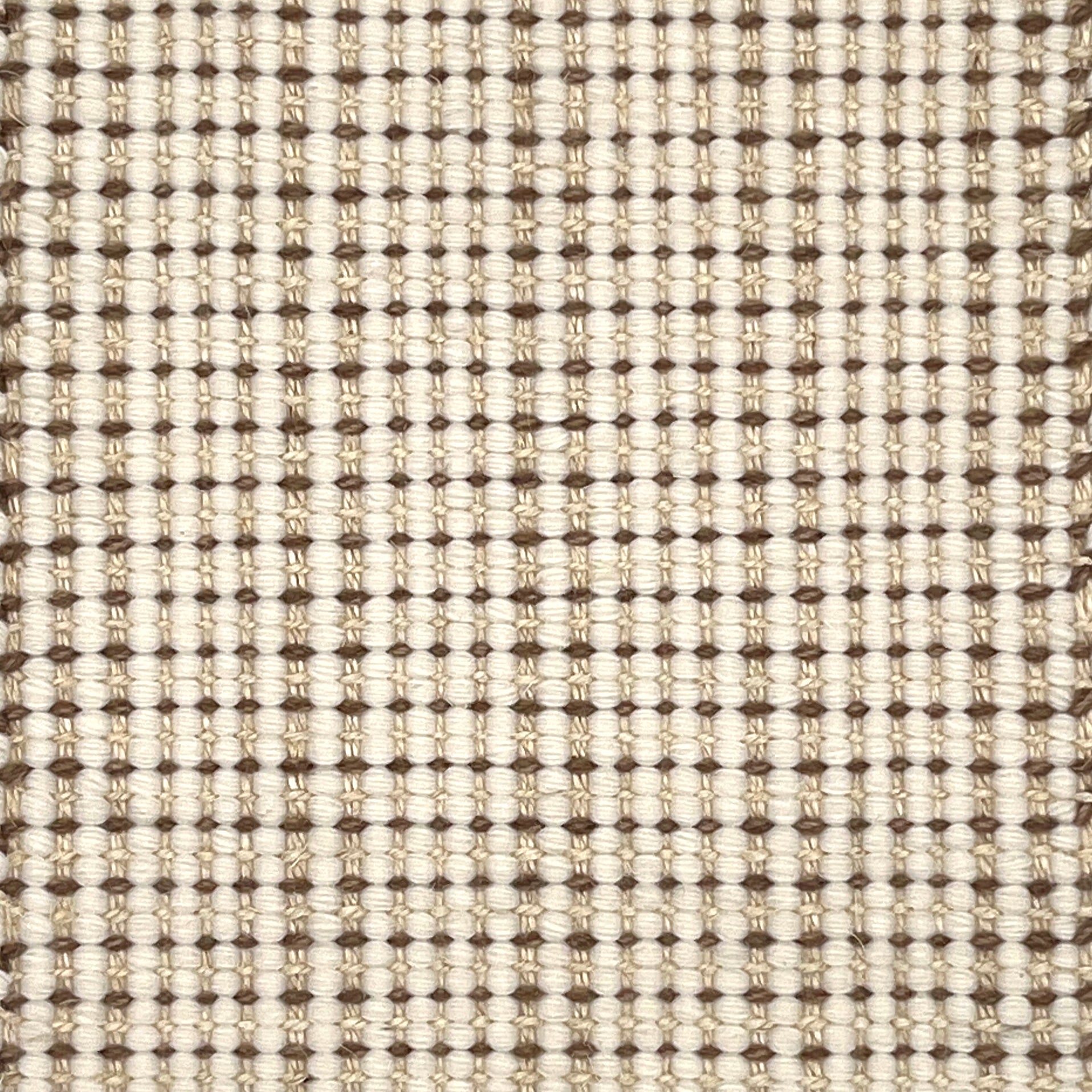 Close-up of a textured handmade rug with a grid pattern in beige and brown.
