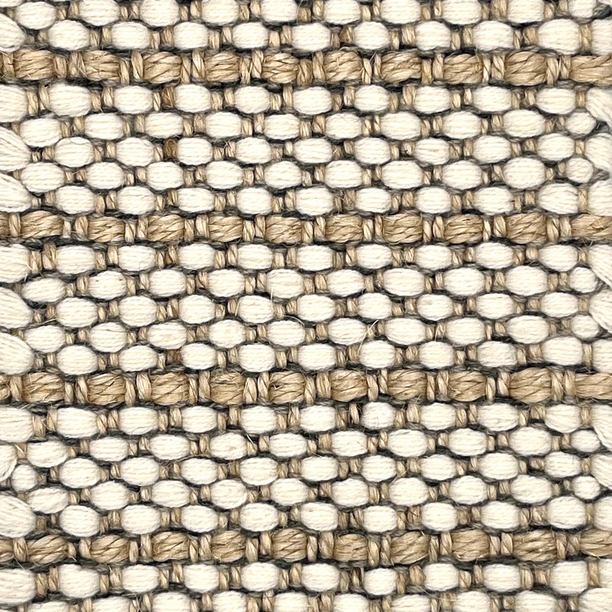 Close-up of a woven striped rug with beige and white colors.