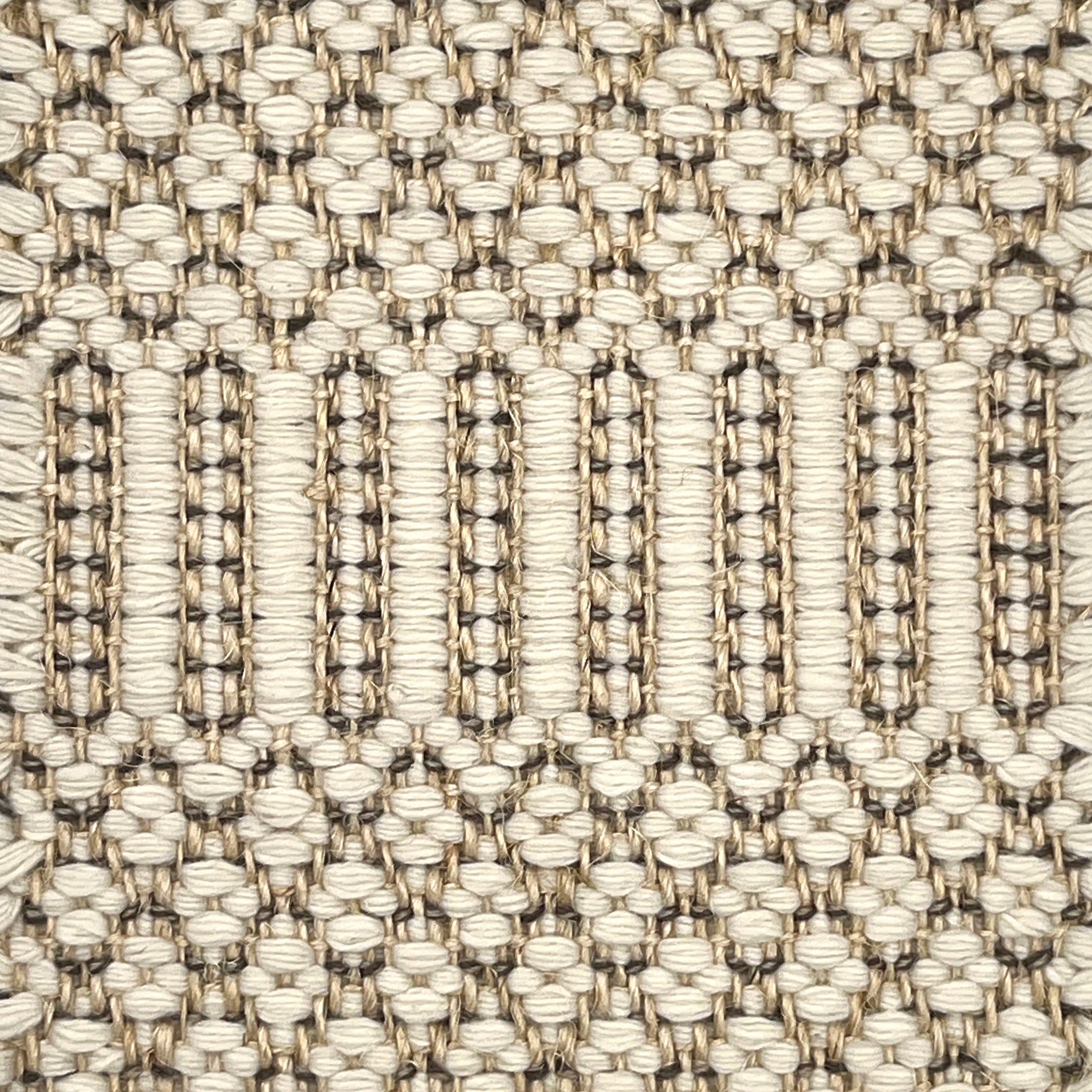 Close-up of a textured flatweave rug with a geometric pattern