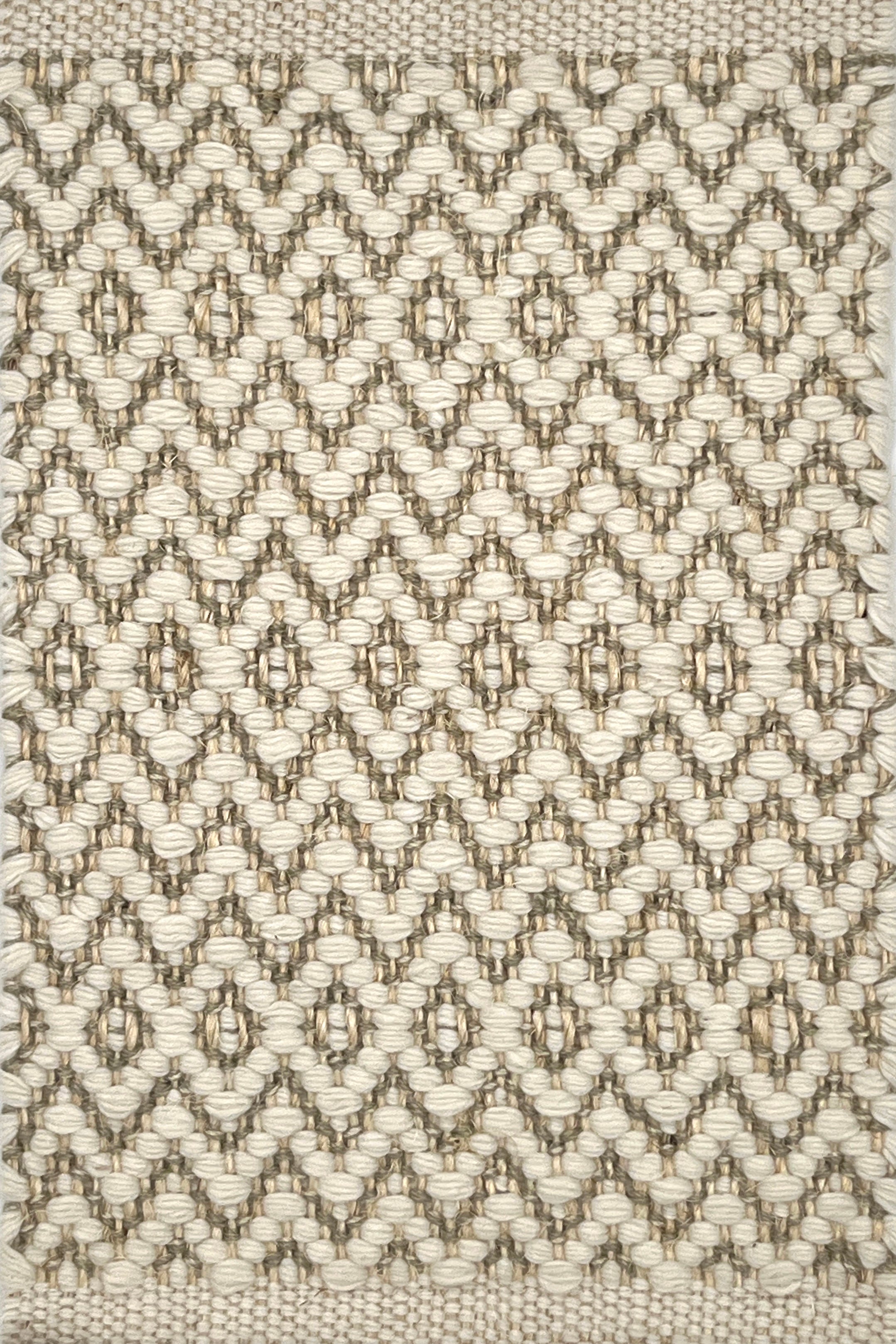 Textured flatweave rug with a diamond pattern in beige and brown tones.
