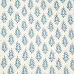 Detail of fabric in a repeating leaf pattern in blue on a cream field.