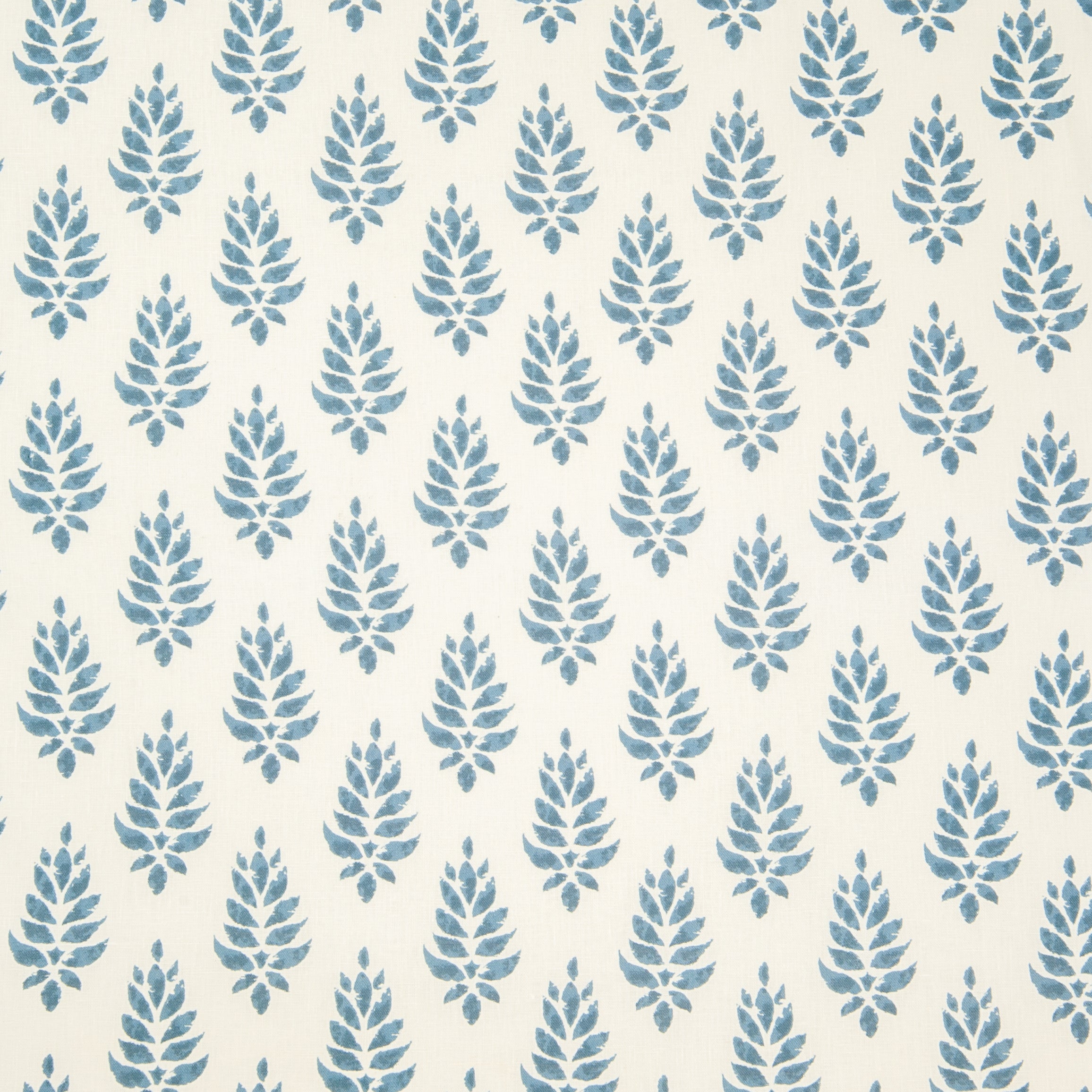 Detail of fabric in a repeating leaf pattern in blue on a cream field.