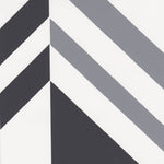 Detail of wallpaper in an irregular chevron stripe in gray and charcoal on a white field.