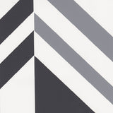 Detail of wallpaper in an irregular chevron stripe in gray and charcoal on a white field.