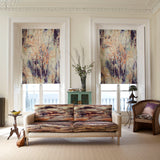 A modernist living space with curtains and a sofa all upholstered in abstract painterly prints.