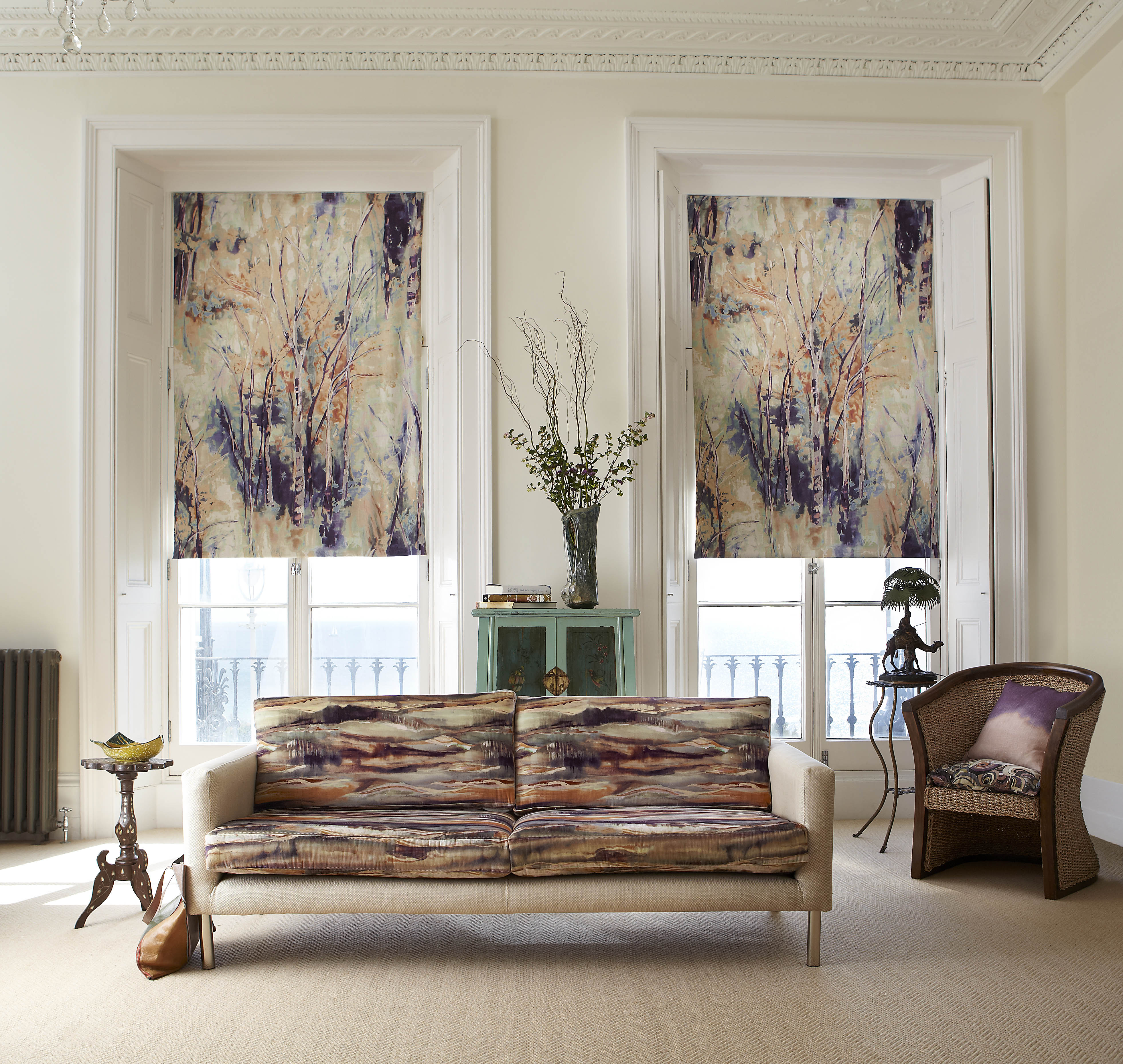 A modernist living space with curtains and a sofa all upholstered in abstract painterly prints.