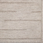 Textured ecru rug with a subtle pattern