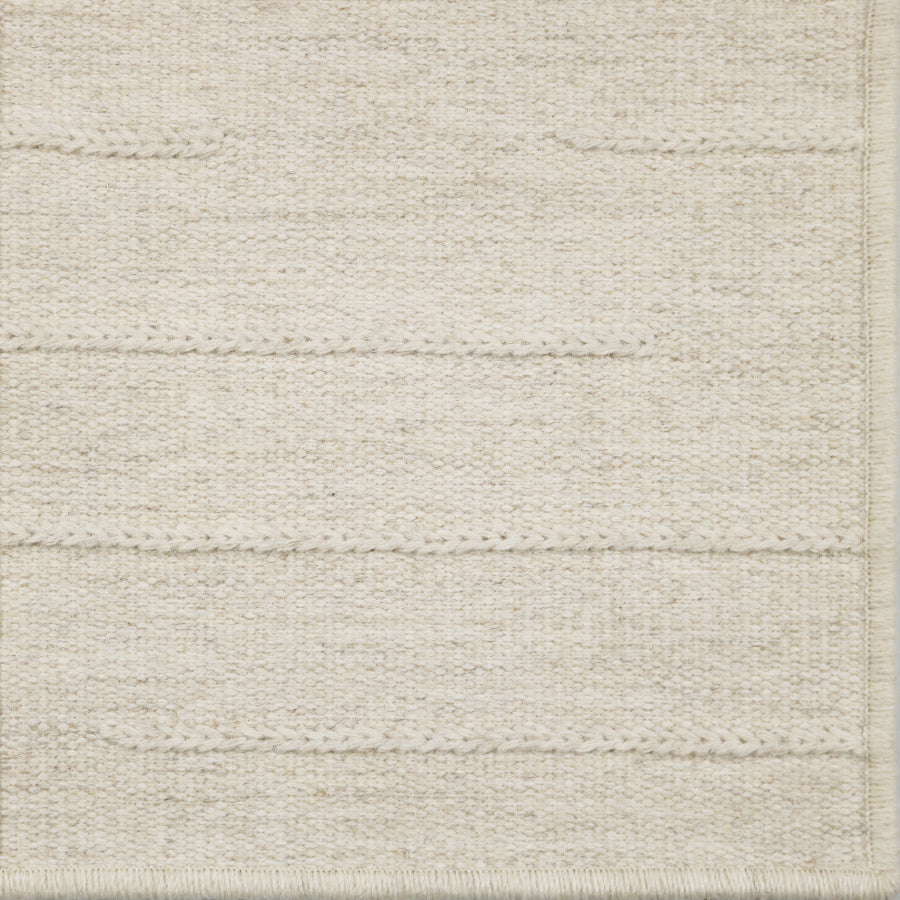 Close-up of a textured broadloom carpet with horizontal lines