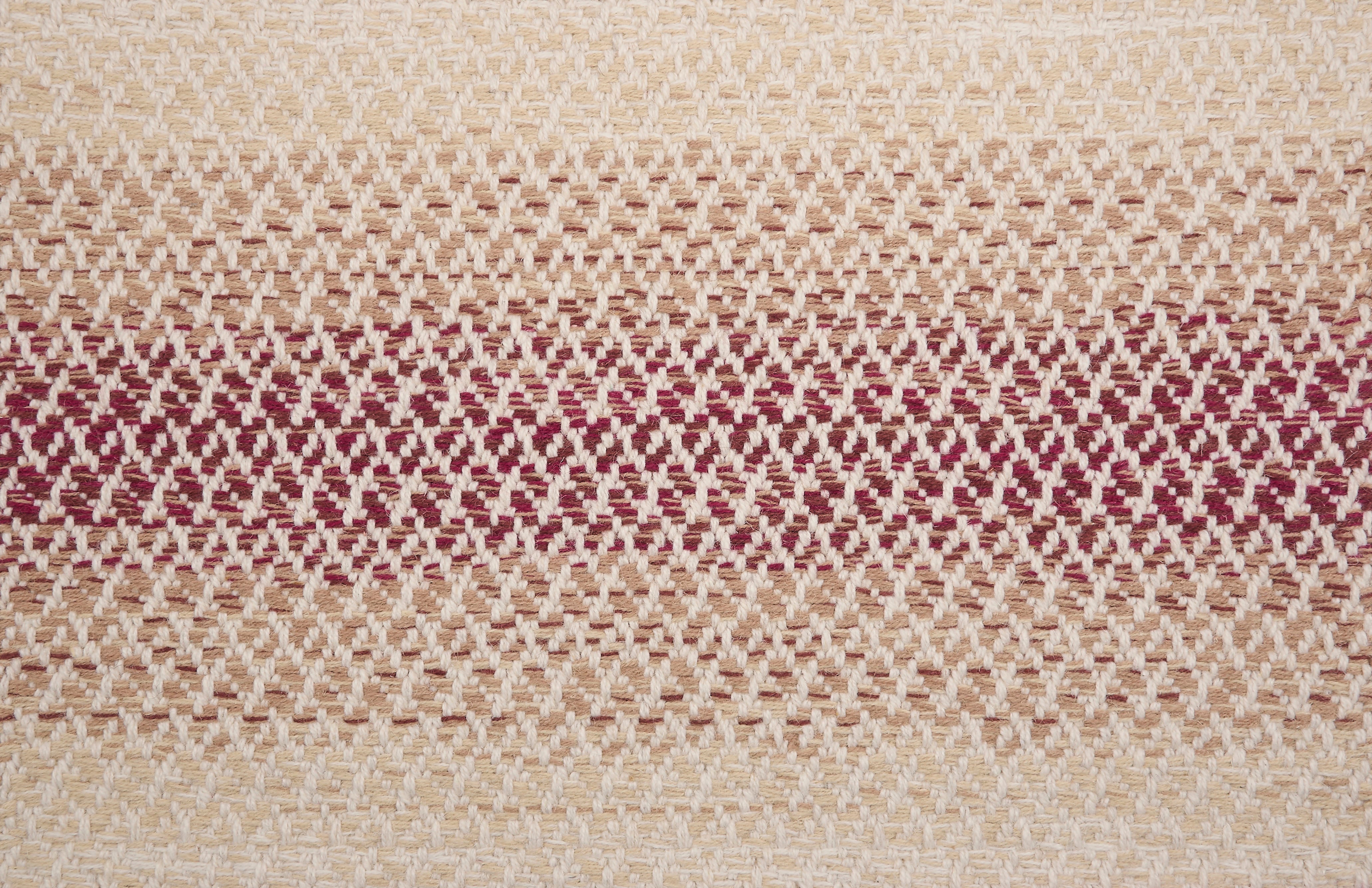 Textural broadloom with an ombré stripe in red and beige. 