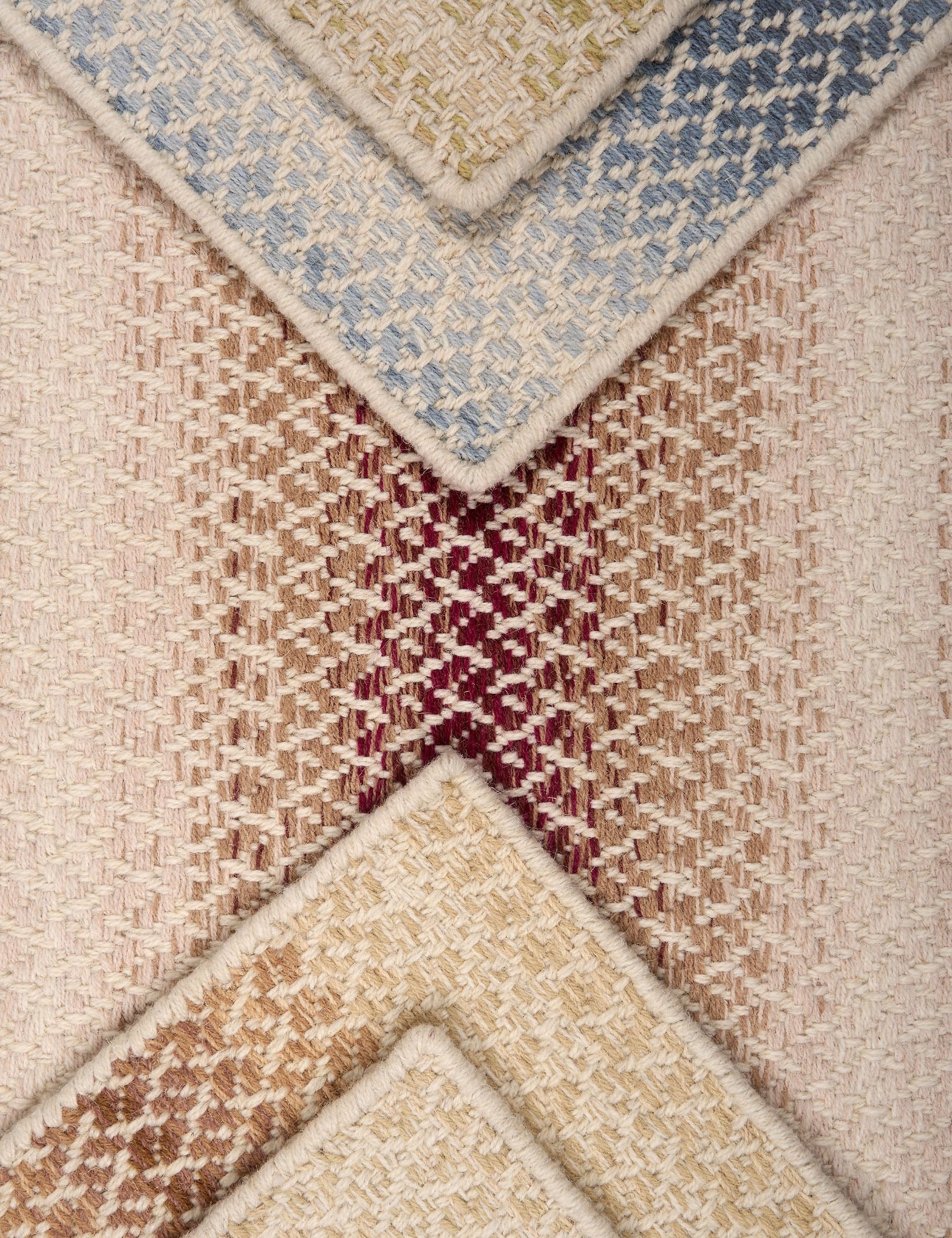 Textural broadloom samples with ombré stripes in various colors.
