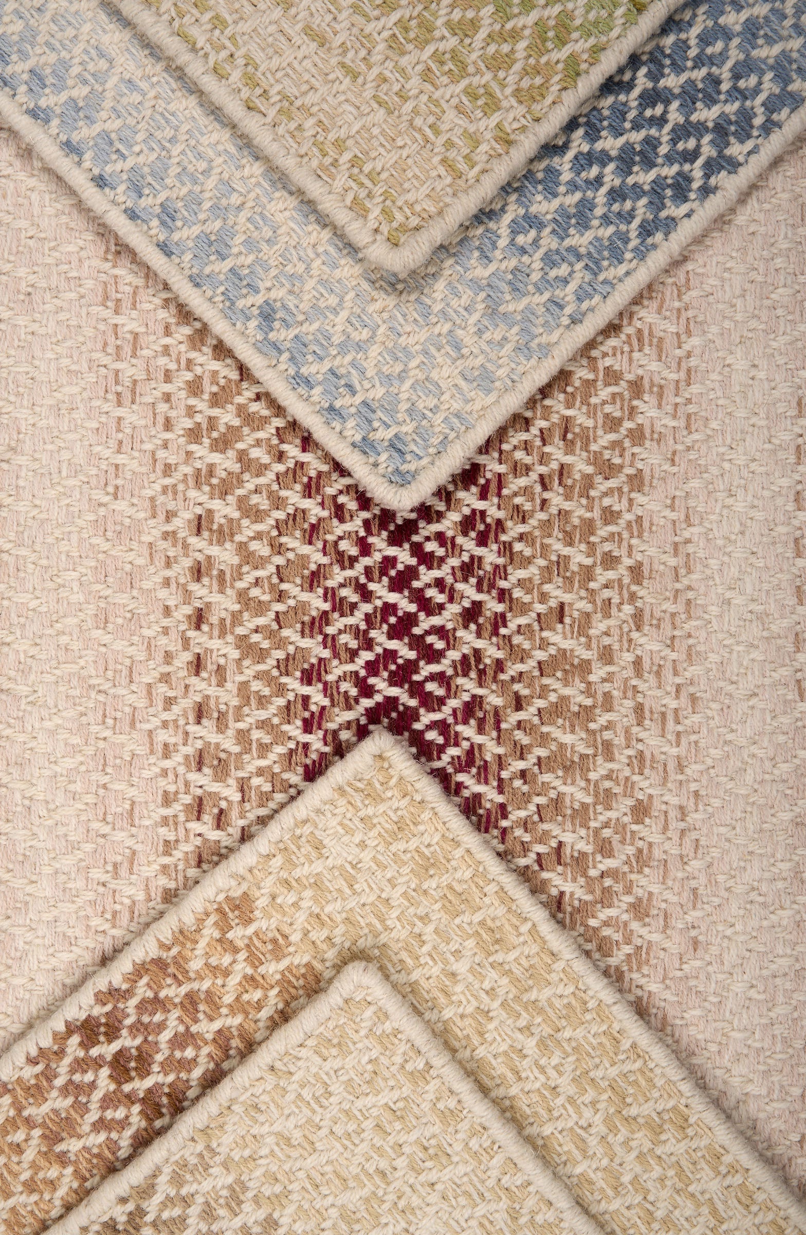 Textural broadloom samples with ombré stripes in various colors.