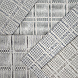 Broadloom carpet samples in a plaid pattern in a range of neutral colors. 