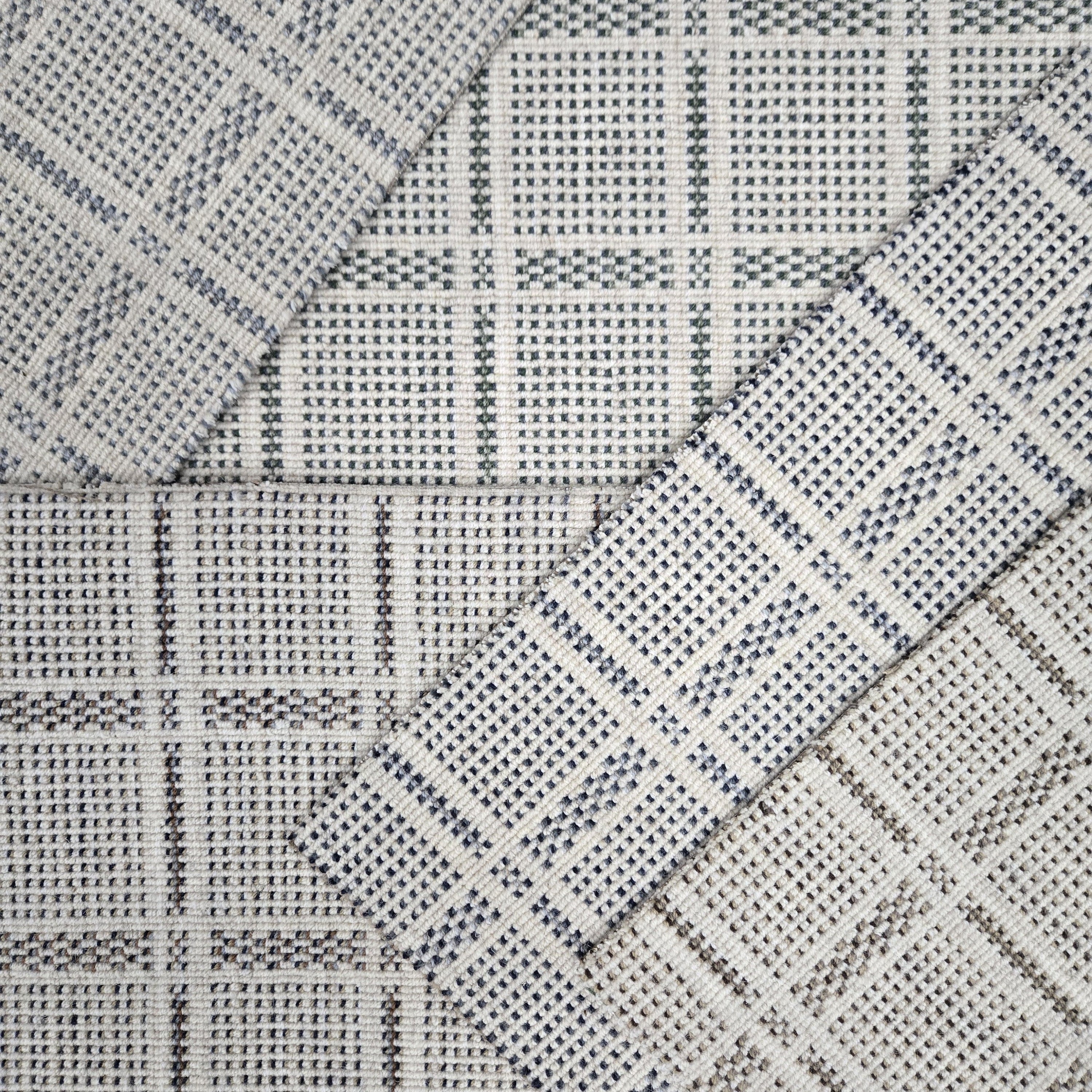 Broadloom carpet samples in a plaid pattern in a range of neutral colors. 