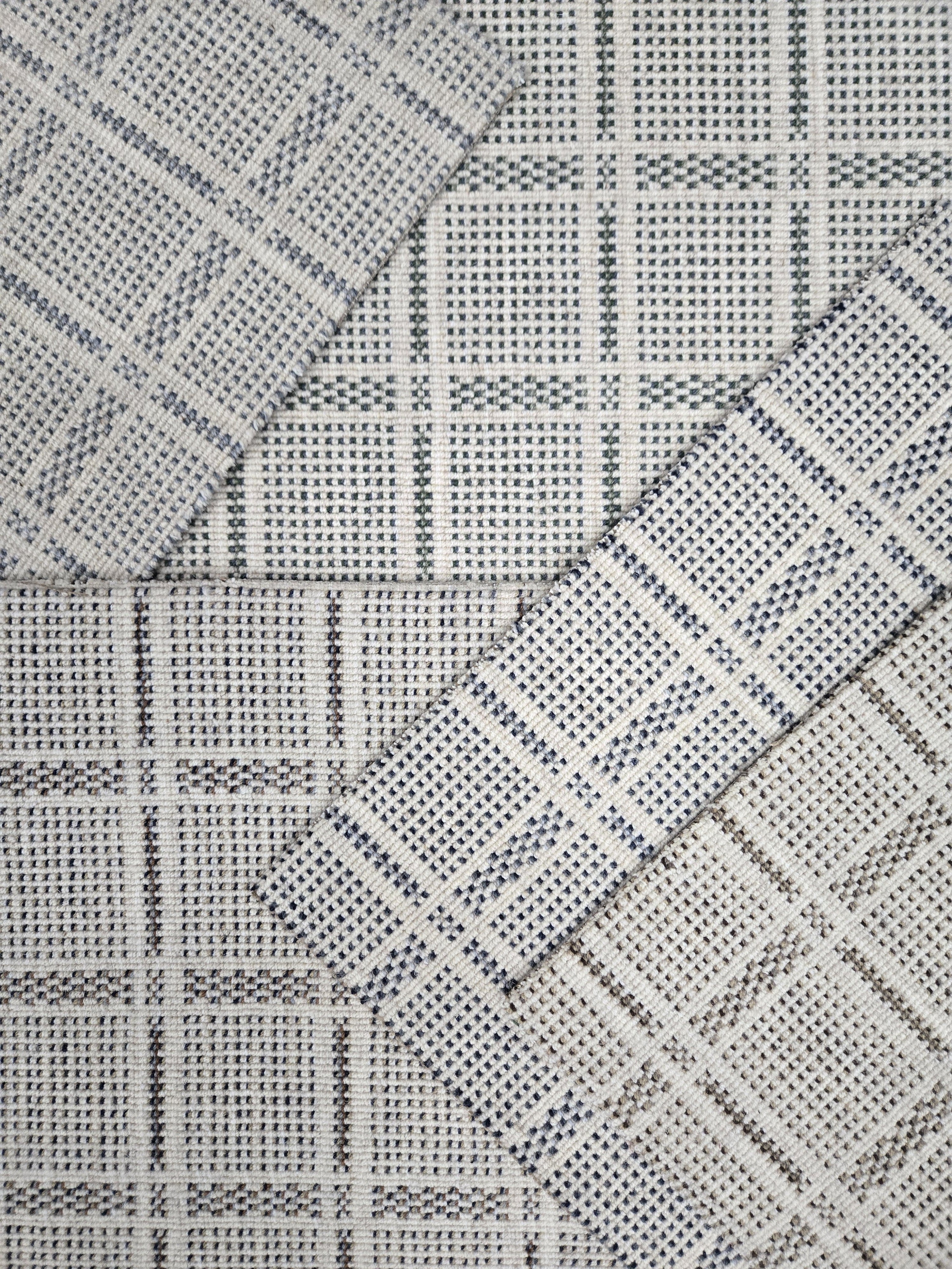 Broadloom carpet samples in a plaid pattern in a range of neutral colors. 